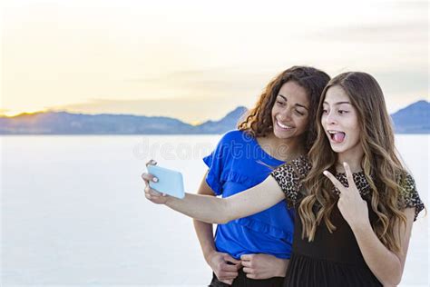 Two Cute And Diverse Teenage Girls Posing And Taking A Selfie Together