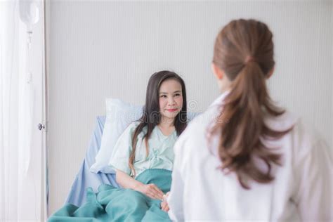 Hands Women Doctor Reassuring Her Female Asian Patient In Hospital Room
