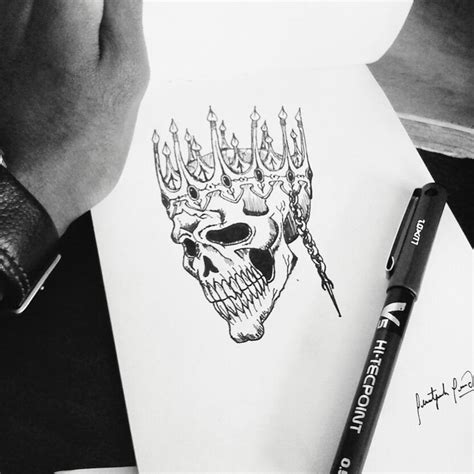 A Drawing Of A Skull With A Crown On Its Head And A Pen Next To It