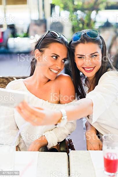 Two Young Beautiful Women Taking A Selfie Of Themselves Stock Photo