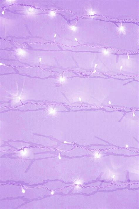 A Purple Background With White Lights And Branches