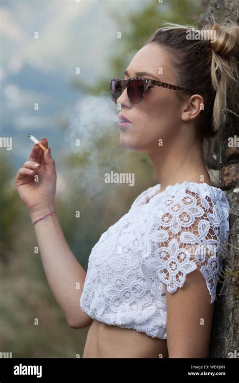 Woman Blowing Cigarette Smoke Hi Res Stock Photography And Images Alamy
