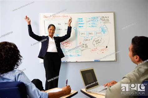 African Businesswoman Cheering In Front Of Whiteboard Stock Photo