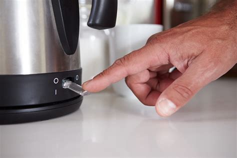 Closeup Of Mans Fingers Flicking Switch To Boil Kettle Stock Photo