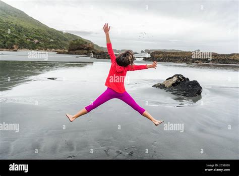 Carefree Happy Girl Jumping Of Fun On Beach Woman Enjoying Outdoor