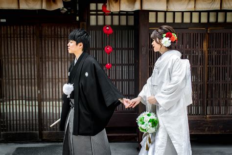 A Young Happy Japanese Couple In Traditional Japanese Wedding Attire On Their Way To Get
