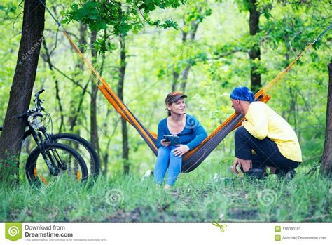 Happy Couple Rests After Riding A Bikes In The Forest Stock Image
