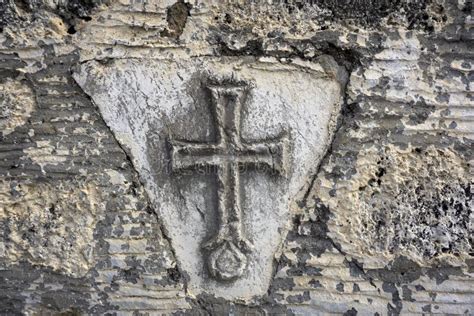 Ancient Greek Christian Cross On The Old Stone Wall Of The Temple Stock