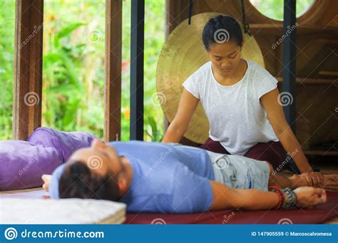 Young Beautiful And Exotic Asian Balinese Wellness Therapist Giving