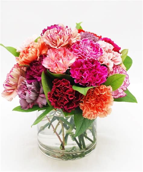 Two Dozen Mixed Color Carnations Arranged In A Vase A Colorful
