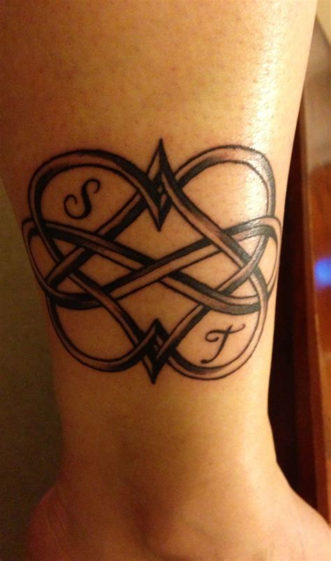 Angel wings back tattoo men. Tattoo with my children's initials with infinity / with a ...