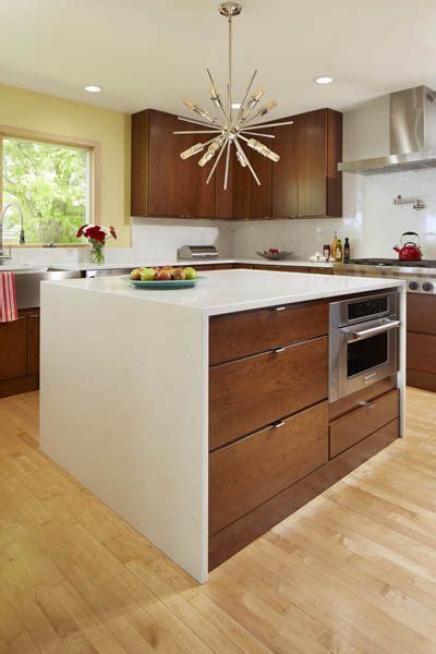 Mid Century Modern Cherry Kitchen Accented By A Waterfall Island Mid