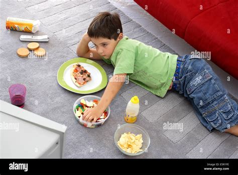 Child Snacking While Watching Tv Stock Photo Alamy