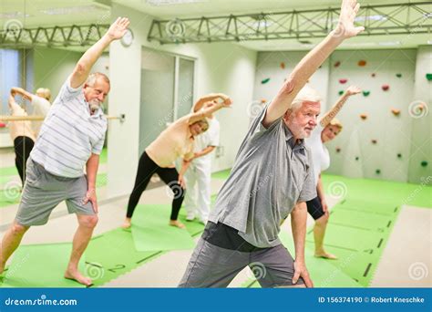 Group Of Seniors Doing Stretching Exercise In Rehab Stock Photo Image