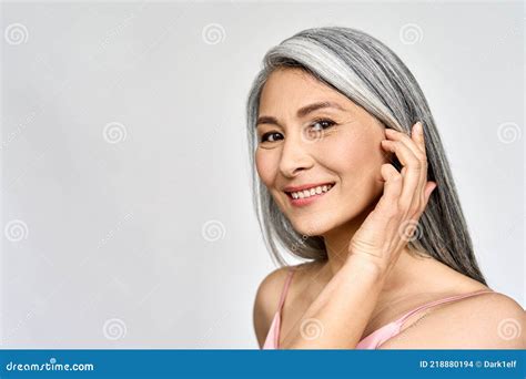 senior happy middle aged mature asian woman headshot portrait skin care advertising stock