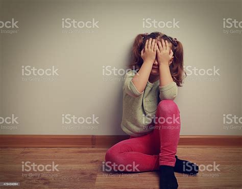 Frightened Crying Kid Girl Sitting On The Floor Stock Photo Download