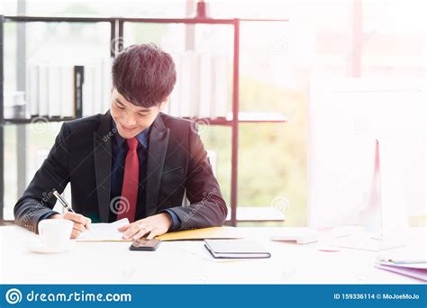 A Happy Young Businessman Signing Documents Stock Photo Image Of