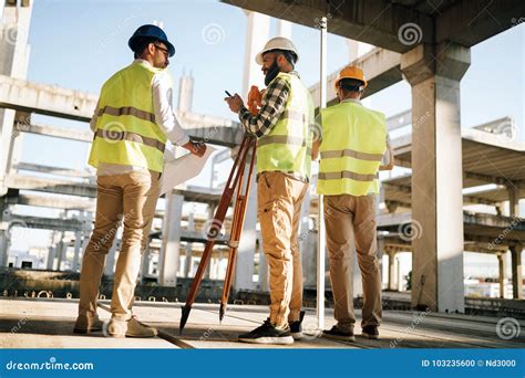 Team Of Construction Engineers Working On Building Site Stock Photo