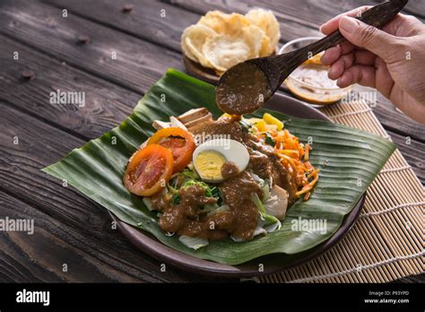 gado gado traditional indonesian food rice cake egg and vegetable with peanut sauce stock