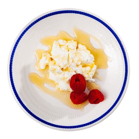 Catalan Whey Cheese Mato Served On Plate With Raspberries And Honey