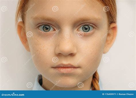 Close Up Portrait Of Child With Big Blue Eyes And Red Hair Stock Image