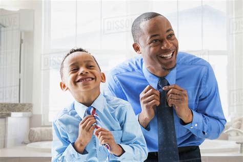 Father And Son Straightening Their Ties Stock Photo Dissolve