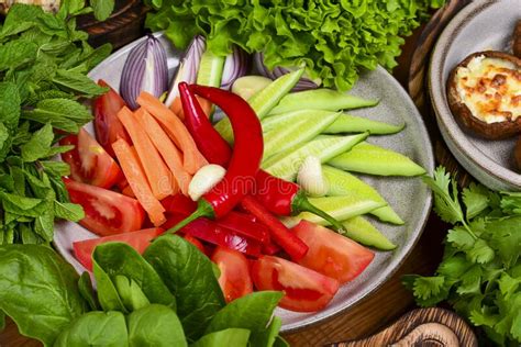 Assortment Of Fresh Cut Vegetables Served In A Plate On Dark Wooden