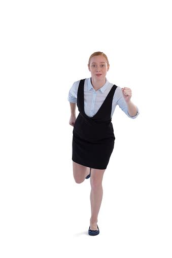 Female Executive Running Against White Background Stock Photo