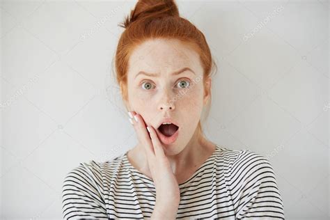 Young Redhead Woman With Surprised Facial Expression