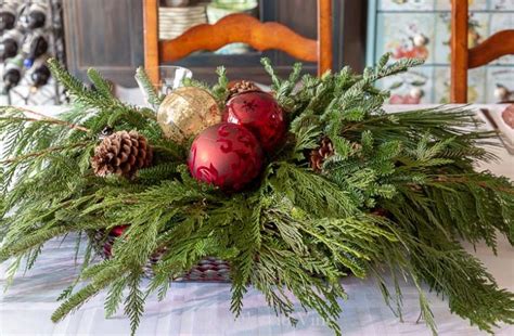 Christmas Table Centerpiece Made With Evergreens And Ornaments Hearth