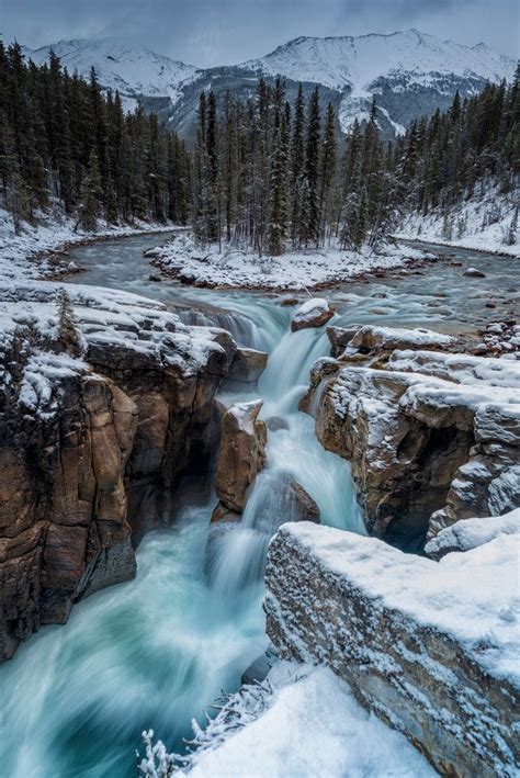 Icy Flow Ice Cold Glacial Water Flows Across A Snowy Landscape At