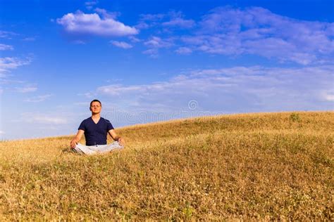 The Peaceful Scenery Of A Man Meditating In The Lotus Position Stock