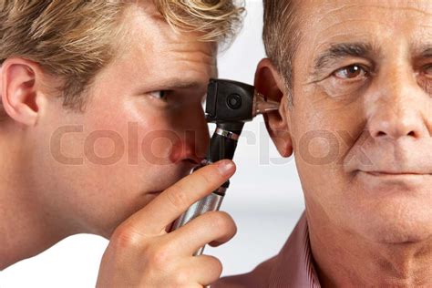 Doctor Examining Male Patient S Ears Stock Image Colourbox