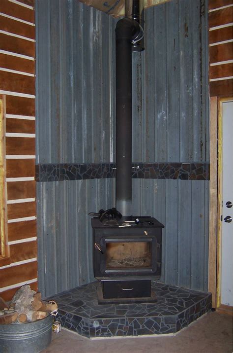 The shield has air vents in the bottom to ensure that air circulates up the back of the shield to protect the wall or furniture. Wood Stove Heat Shield Ideas | Examples and Forms