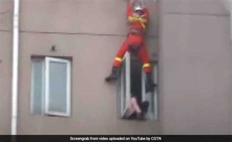 Video Firefighter Saves Suicidal Woman By Kicking Her Back Into Home