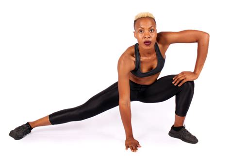 woman stretching legs with side lunge hamstring stretch stretching after workout