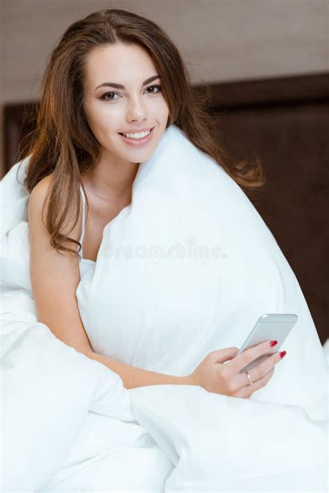 Happy Woman Sitting On The Bed Under Blanket Stock Photo Image Of