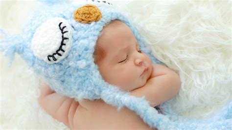 Cute Newborn Baby Is Sleeping On White Woolen Bed Wearing Knitted Woolen Blue Cap Hd Cute