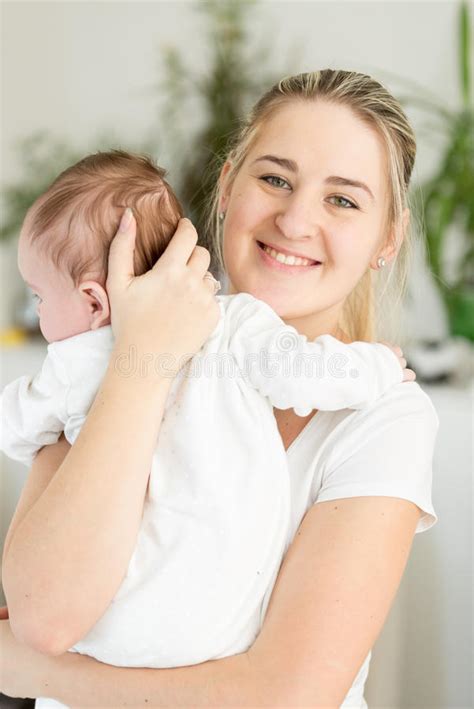 Beautiful Smiling Mother Cuddling Her 3 Months Old Baby Stock Photo