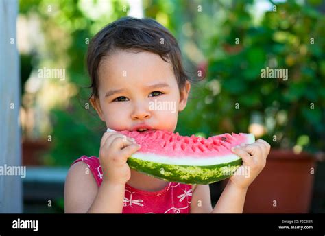 Happy Little Girl Eating Watermelon Stock Photo Alamy