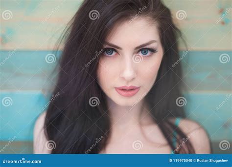 Portrait Of Pretty Caucasian Girl With Blue Eyes On Colorful Wooden