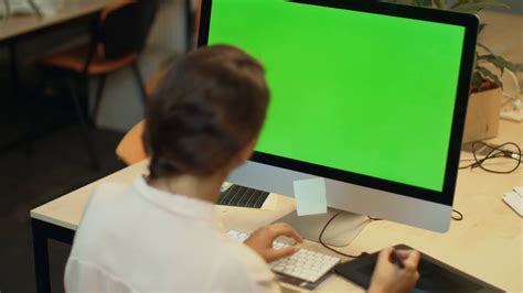 young woman working  computer  green screen  office graphic designer making correction