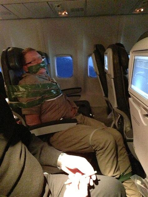 the moment drunken passenger is taped to his seat during flight to new york after trying to
