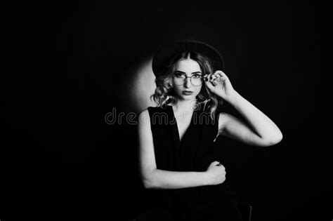 Studio Portrait Of Blonde Girl In Black Wear Red Hat Stock Photo