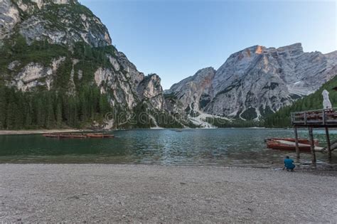 Unrecognizable Photographer On The Beach Of Lake Braies At Sunset