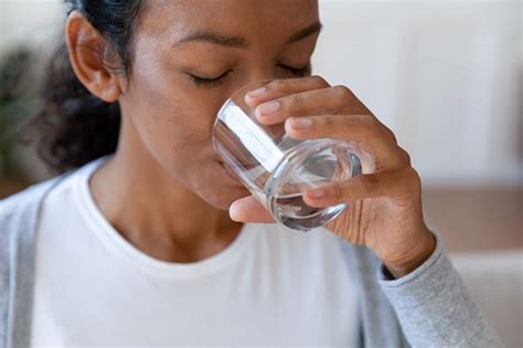 Close Up Of African American Woman Drinking Water Stock Photo