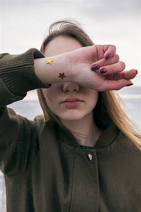 Young Woman Covering Her Eyes With Hand By Stocksy Contributor Danil