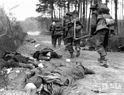 British Soldiers Pass The Dead Bodies Of German Soldiers During Their