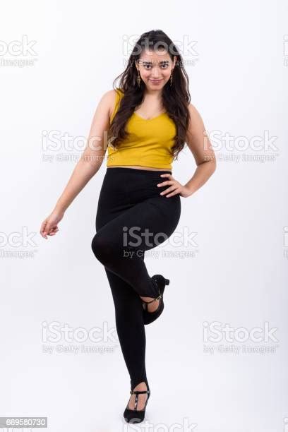 Full Body Shot Of Young Beautiful Indian Woman Posing With One Leg