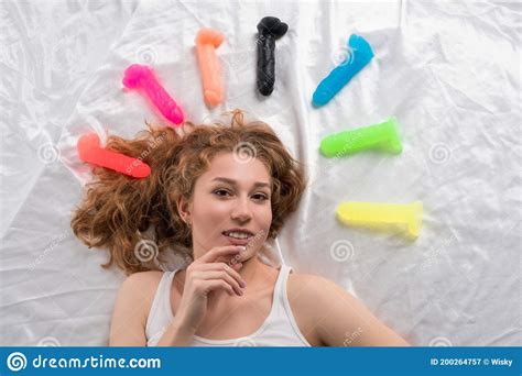 Smiling Woman Lying On Bed With Colorful Sex Toys Stock Image Image Of Colorful Choice 200264757
